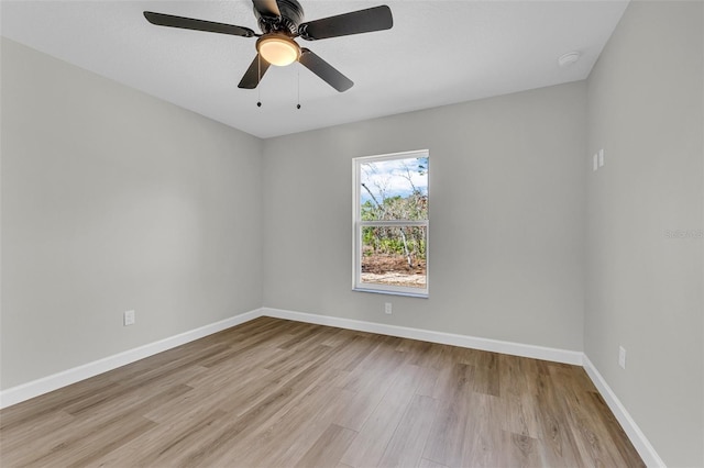 empty room featuring light hardwood / wood-style flooring and ceiling fan