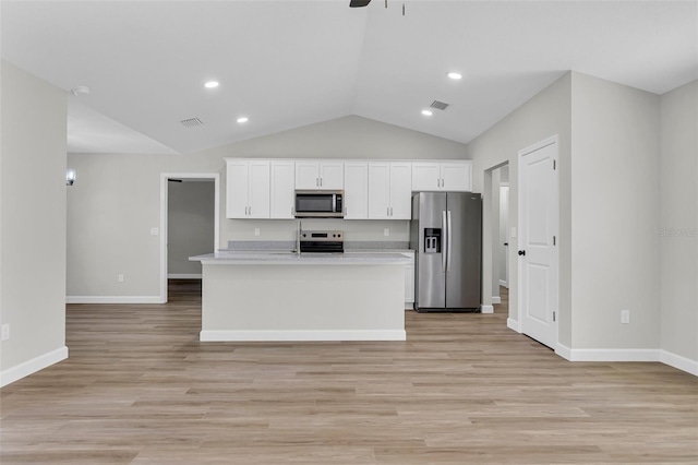 kitchen featuring white cabinetry, an island with sink, stainless steel appliances, and light hardwood / wood-style floors