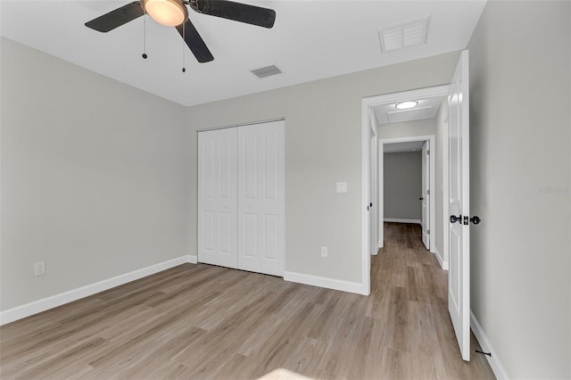 unfurnished bedroom featuring light wood-type flooring, a closet, and ceiling fan