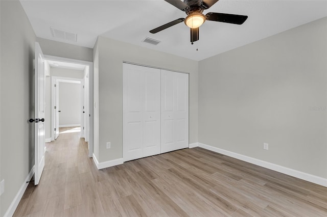 unfurnished bedroom with a closet, light hardwood / wood-style flooring, and ceiling fan