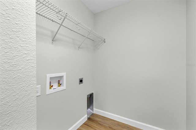 washroom featuring hardwood / wood-style floors, electric dryer hookup, and hookup for a washing machine