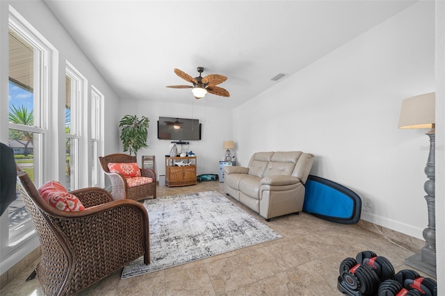 living room with ceiling fan and plenty of natural light