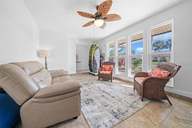 living room with light tile patterned floors and ceiling fan