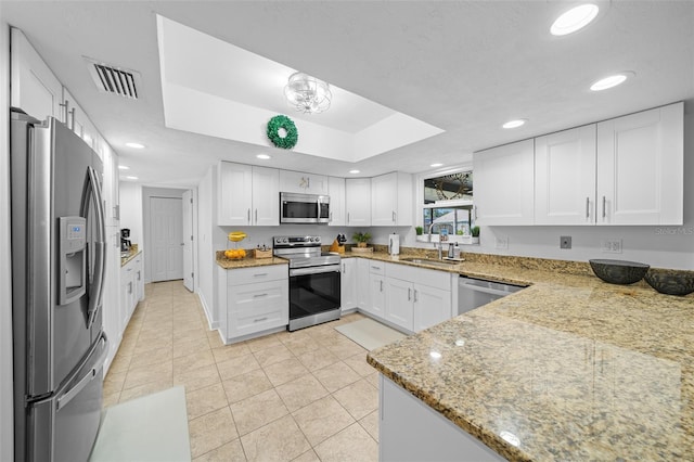 kitchen with white cabinetry, sink, light tile patterned floors, stainless steel appliances, and light stone countertops