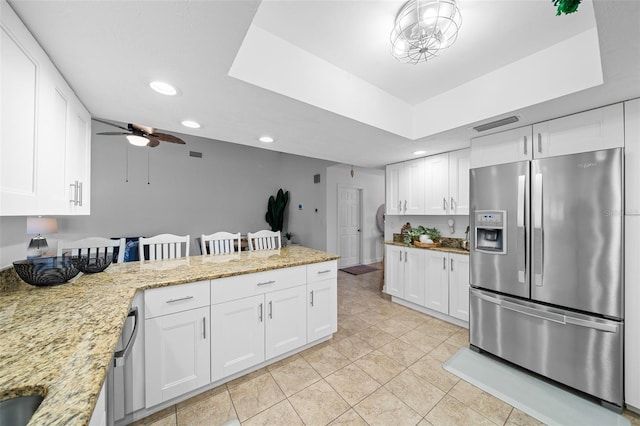 kitchen with white cabinets and stainless steel fridge