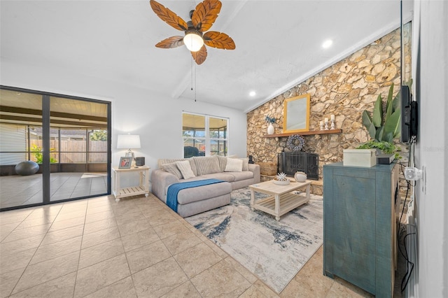 living room featuring ceiling fan, vaulted ceiling with beams, a wealth of natural light, and a fireplace