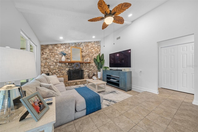 living room featuring ceiling fan, a fireplace, high vaulted ceiling, and light tile patterned floors