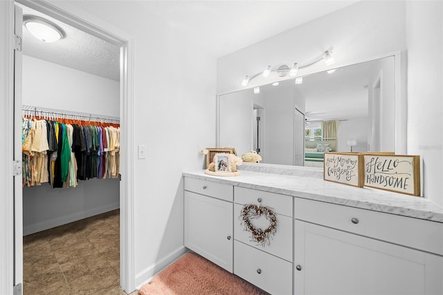 bathroom with vanity and a textured ceiling