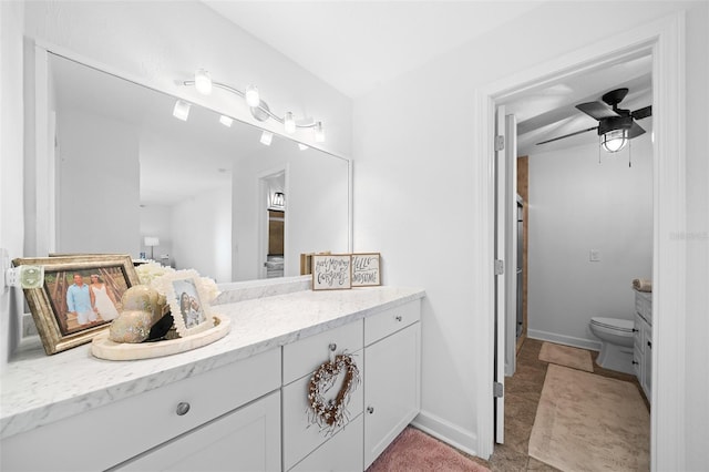 bathroom featuring vanity, toilet, and ceiling fan