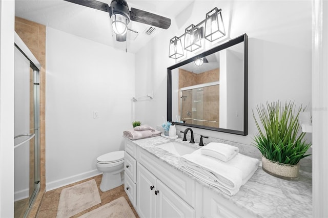 bathroom featuring ceiling fan, vanity, toilet, and a shower with shower door