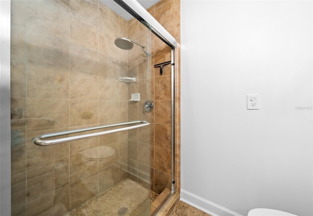 bathroom with walk in shower and toilet