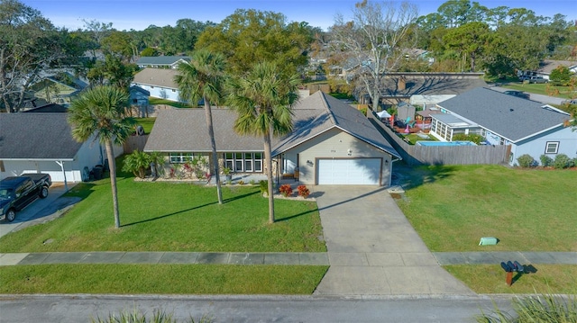 view of front of house featuring a garage and a front lawn