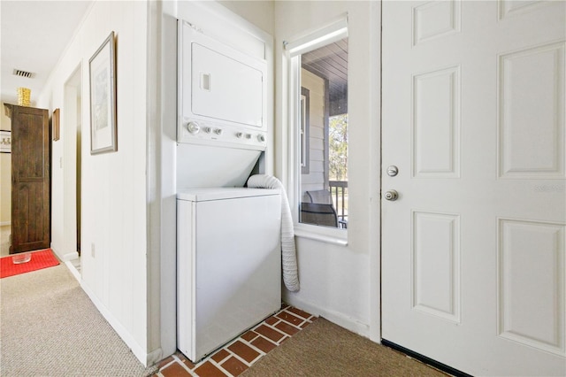 clothes washing area with stacked washer / drying machine