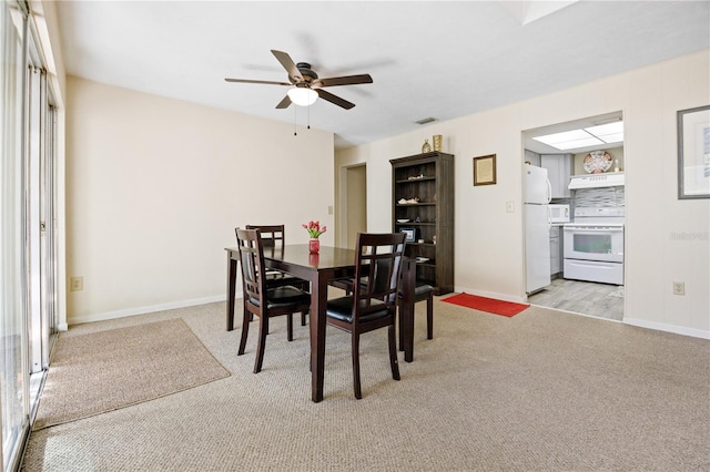 carpeted dining area featuring ceiling fan