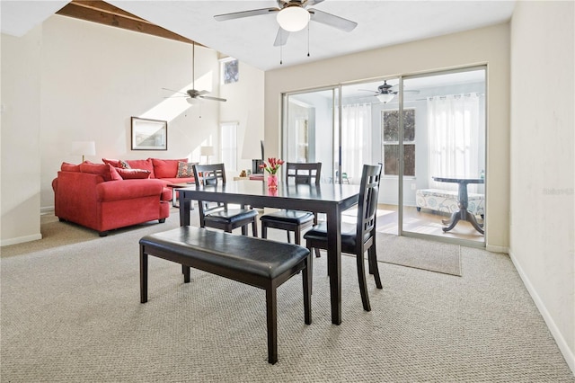 carpeted dining room featuring ceiling fan and vaulted ceiling