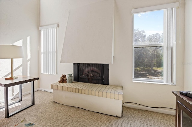 living room with light colored carpet and a brick fireplace