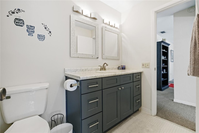 bathroom featuring tile patterned floors, vanity, and toilet