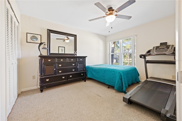 carpeted bedroom with a closet and ceiling fan