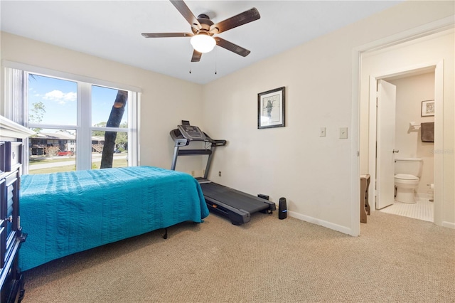 bedroom with connected bathroom, ceiling fan, and carpet