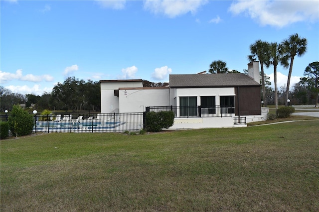 exterior space with a front yard and a community pool