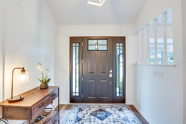 entryway with dark wood-type flooring and a healthy amount of sunlight