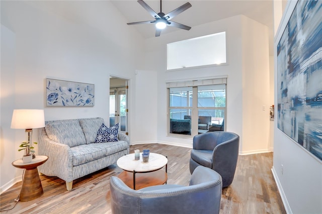 living room with ceiling fan, high vaulted ceiling, and hardwood / wood-style flooring