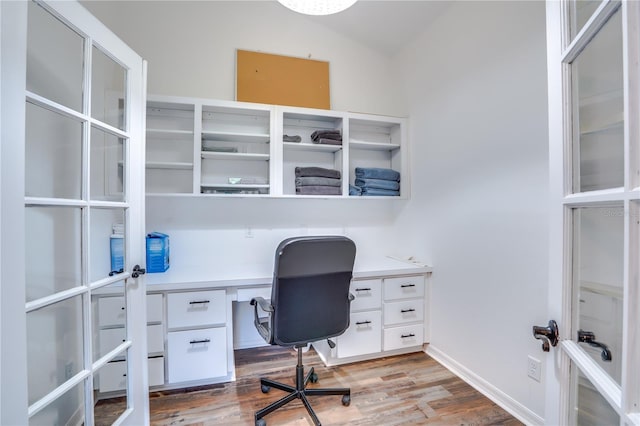 office with wood-type flooring and lofted ceiling