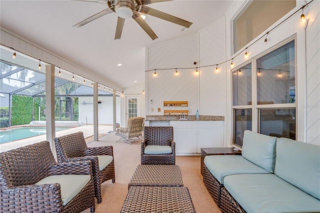 interior space with ceiling fan, lofted ceiling, and sink