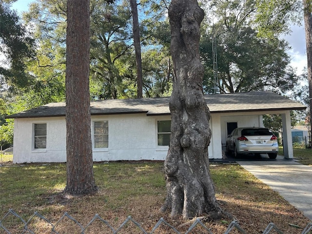 view of side of home with a carport