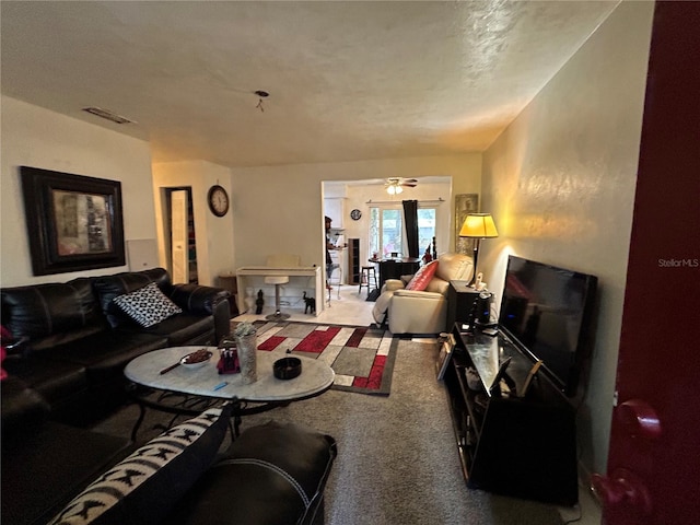 carpeted living area featuring visible vents