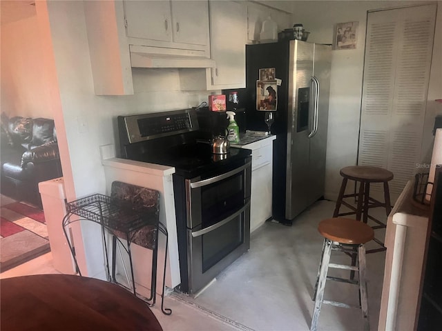 kitchen with appliances with stainless steel finishes, white cabinetry, concrete floors, and under cabinet range hood