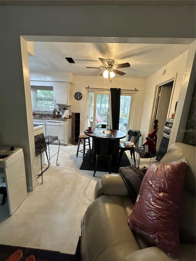 living room with a ceiling fan and light colored carpet