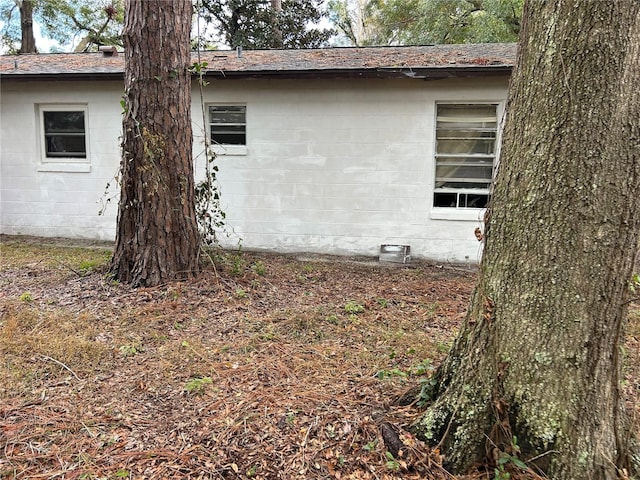 view of side of property with concrete block siding