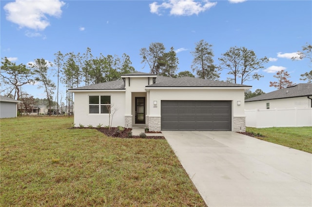 prairie-style house with stucco siding, concrete driveway, a front yard, fence, and a garage