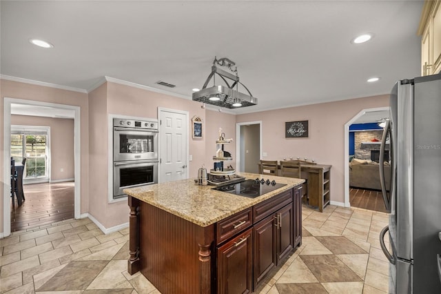 kitchen featuring light stone countertops, pendant lighting, a kitchen island, appliances with stainless steel finishes, and ornamental molding