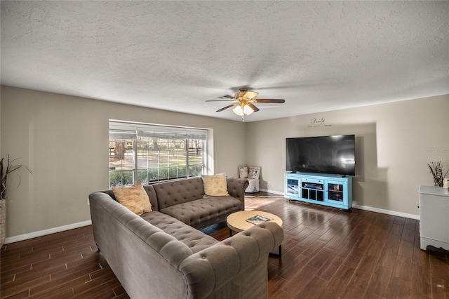 living room with ceiling fan, a textured ceiling, and dark hardwood / wood-style floors