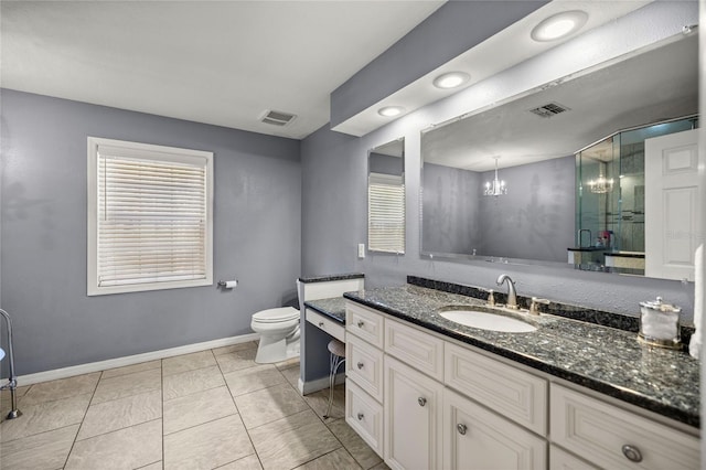 bathroom with toilet, vanity, plenty of natural light, and a notable chandelier