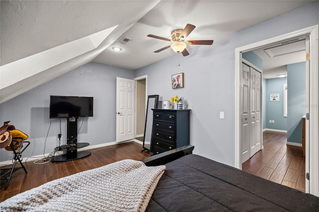 bedroom with ceiling fan, dark wood-type flooring, a closet, and lofted ceiling