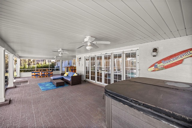 sunroom featuring ceiling fan