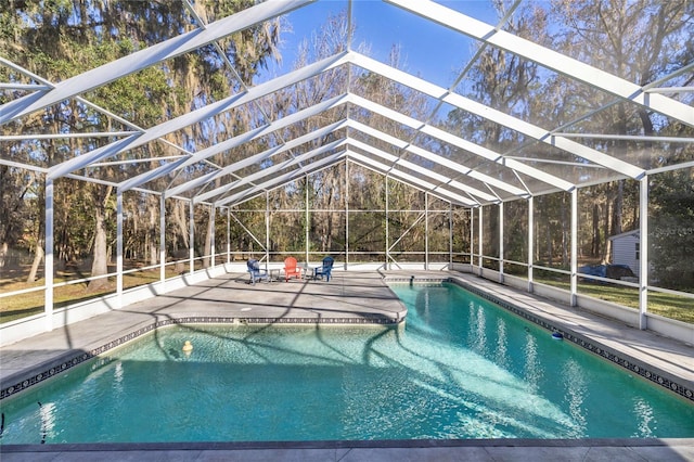 view of swimming pool featuring a lanai and a patio area