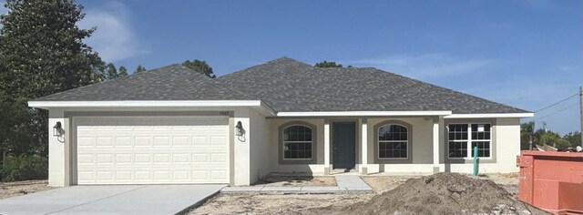 7889 N Omega Way, Citrus Springs, FL 34434 - single story home featuring an attached garage, a shingled roof, driveway, and stucco siding