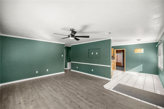 spare room with hardwood / wood-style flooring, ceiling fan, and ornamental molding