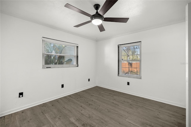 spare room featuring ornamental molding, ceiling fan, and dark wood-type flooring