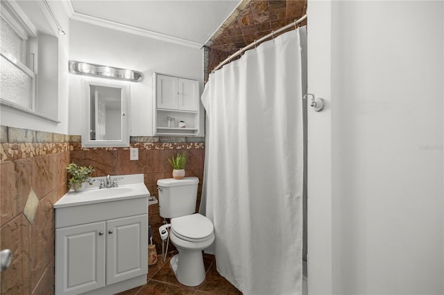 bathroom with vanity, a shower with shower curtain, toilet, ornamental molding, and tile walls