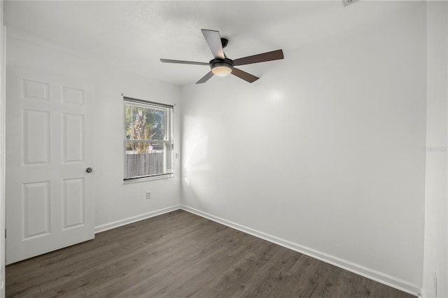 empty room featuring ceiling fan and dark wood-type flooring