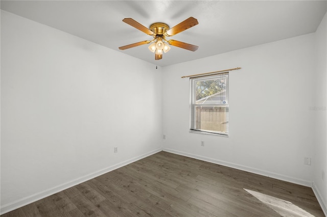 spare room featuring ceiling fan and dark hardwood / wood-style floors