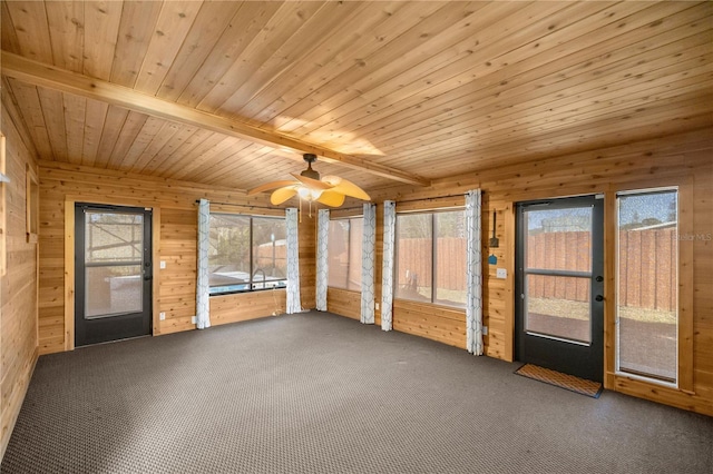 unfurnished sunroom featuring plenty of natural light, beam ceiling, wood ceiling, and ceiling fan