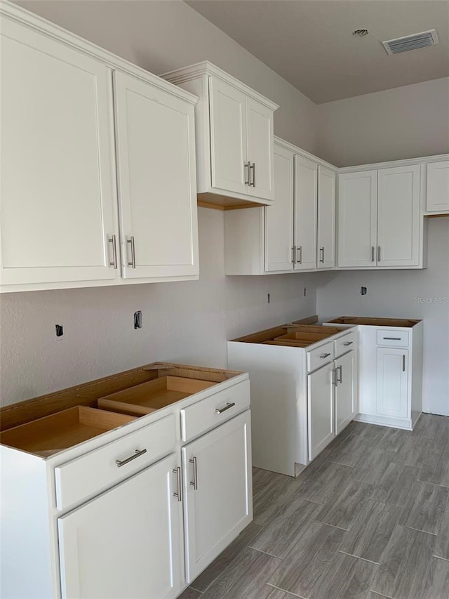 kitchen featuring light wood-type flooring and white cabinets