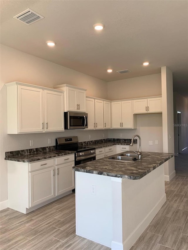 320 W Rexford Dr, Beverly Hills, FL 34465 - kitchen with light wood-type flooring, visible vents, stainless steel appliances, and a sink