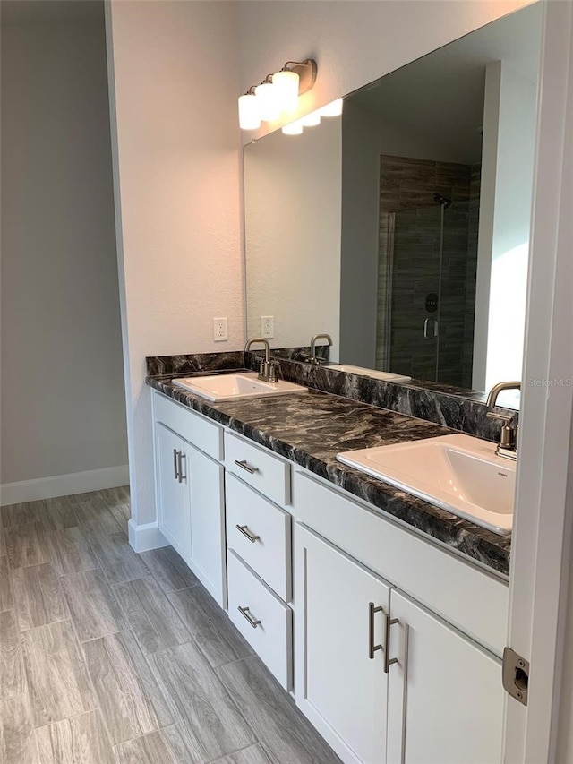 320 W Rexford Dr, Beverly Hills, FL 34465 - full bathroom featuring baseboards, a sink, a shower stall, and double vanity
